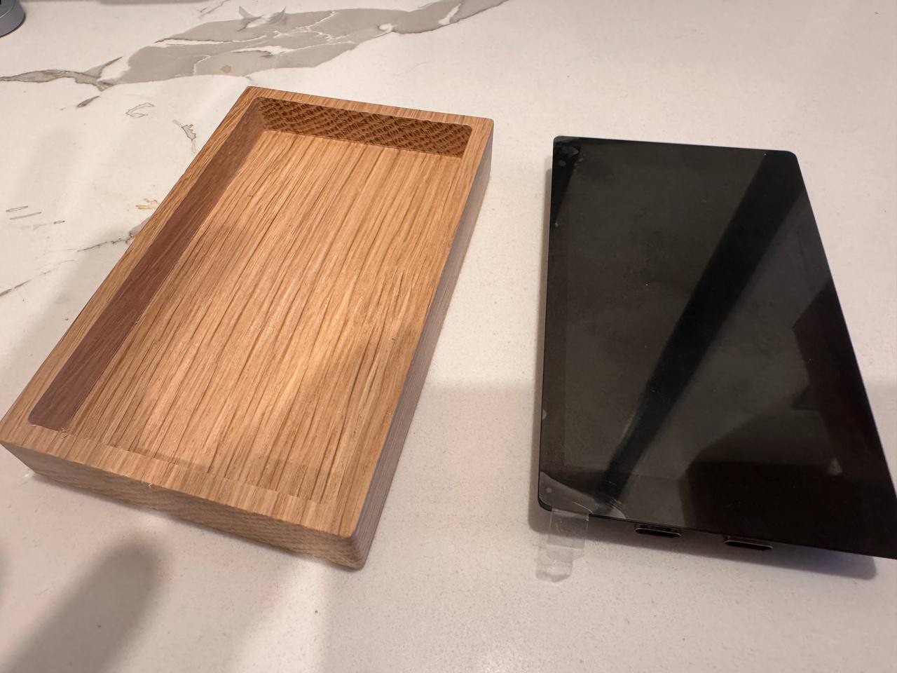 A freshly CNC-milled single-device elm tray beside the bare Kern touchscreen device.